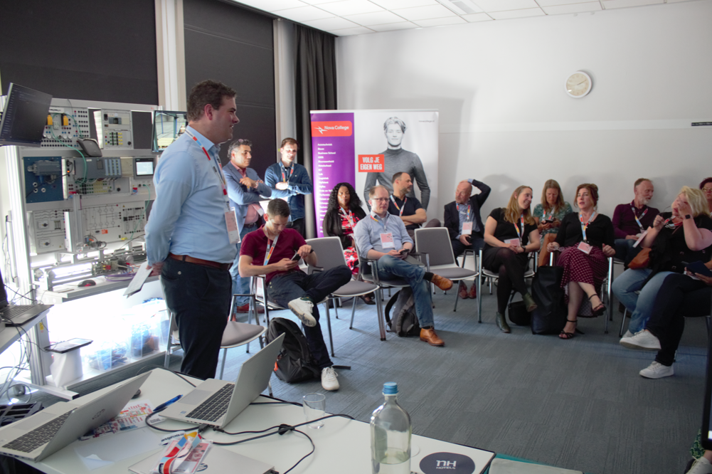 A presenter addresses a seated screenplay workshop group.